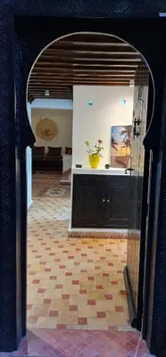 an archway in a room with a vase on a counter at Riad Dar Fatna in Marrakech