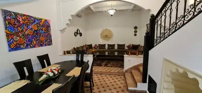 a living room with a table and a couch at Riad Dar Fatna in Marrakech