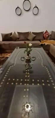 a living room with a table with a flower on it at Riad Dar Fatna in Marrakech