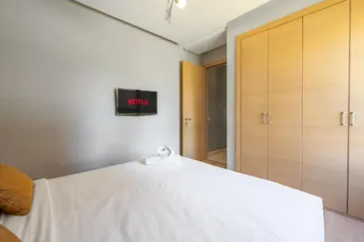 a bedroom with a bed with a tv on the wall at Elegant Apartment in Prestigia Golf Marrakech in Marrakech