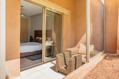 a room with a glass door leading to a bedroom at Elegant Apartment in Prestigia Golf Marrakech in Marrakech