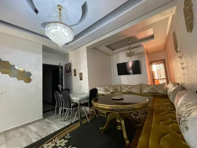 a living room with a couch and a table at Plaza sejour in Marrakech