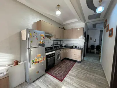 a kitchen with a refrigerator and a dishwasher at Plaza sejour in Marrakech