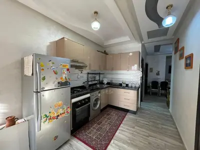a kitchen with a refrigerator and a stove top oven at Plaza sejour in Marrakech