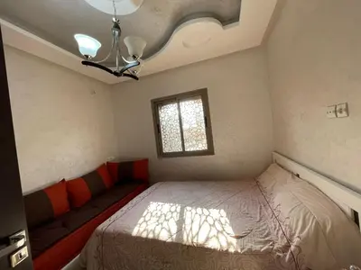 a small bedroom with a bed and a window at Plaza sejour in Marrakech