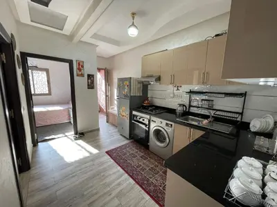 a kitchen with a sink and a stove at Plaza sejour in Marrakech