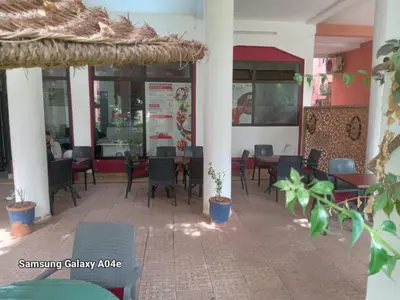 a restaurant with tables and chairs and a menu at 4 bedrooms house & swimming pool in Marrakech