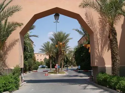 an archway leading to a street with palm trees at 4 bedrooms house & swimming pool in Marrakech