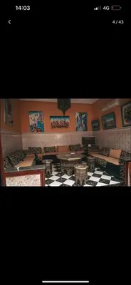 a picture of a room with tables and pictures on the wall at 4 bedrooms house & swimming pool in Marrakech