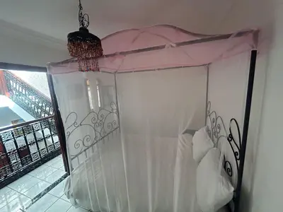 a bed with a canopy in a room at 4 bedrooms house & swimming pool in Marrakech