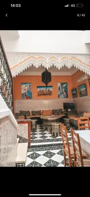 a room with a table and chairs and a tiled floor at 4 bedrooms house & swimming pool in Marrakech