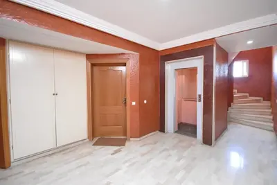 an empty room with orange walls and white doors at Appartement au Coeur de quartier Majorelle in Marrakech