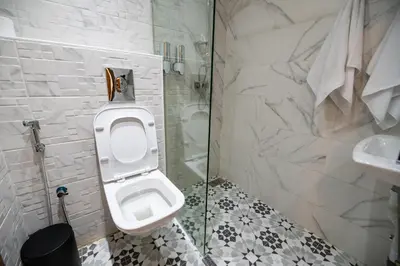 a bathroom with a toilet and a sink and a shower at Jawhar Appart in Marrakech