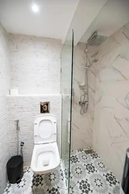 a bathroom with a toilet and a shower at Jawhar Appart in Marrakech