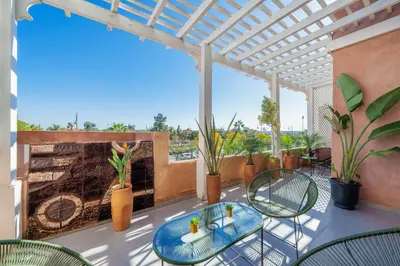 a patio with a table and chairs and a fireplace at 2 Bedrooms Equipped apart in Marrakech
