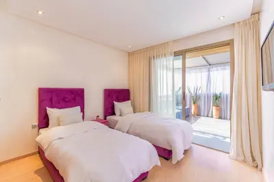 a bedroom with two beds and a large window at 2 Bedrooms Equipped apart in Marrakech