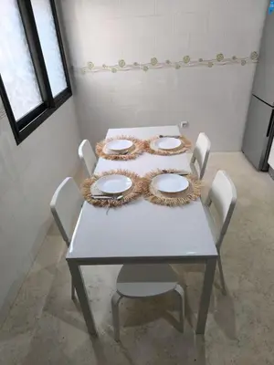 a table with four plates on it in a room at Appartement Piscine à Marrakech in Marrakech