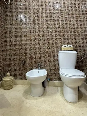 a bathroom with a toilet and a sink at Appartement Piscine à Marrakech in Marrakech