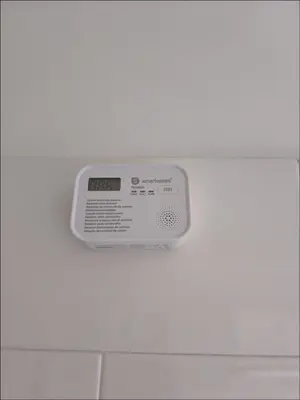 a digital clock on the wall of a bathroom at Appartement Piscine à Marrakech in Marrakech