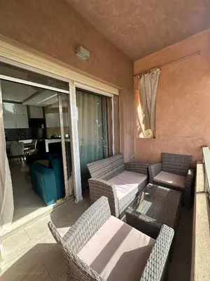a living room with a couch and chairs and a table at l'écrin de prestigia agate studio in Marrakech