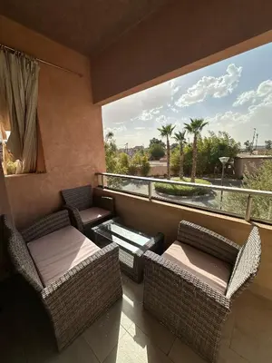 a balcony with wicker furniture and a large window at l'écrin de prestigia agate studio in Marrakech