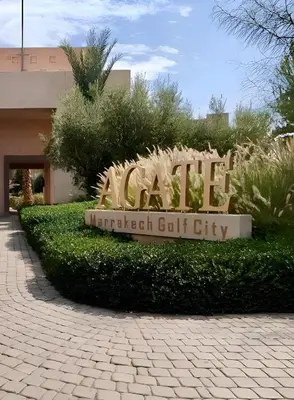 a sign for a park in front of a building at l'écrin de prestigia agate studio in Marrakech