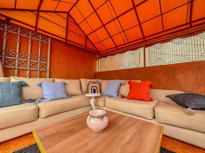 a living room with a couch with colorful pillows at Rare ! duplex avec vue sur les toits de Marrakech in Marrakech