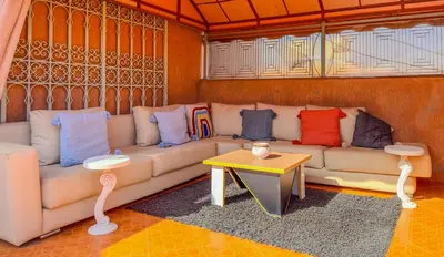 a living room with a couch and a table at Rare ! duplex avec vue sur les toits de Marrakech in Marrakech