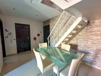 a dining room with a glass table and white chairs at Rare ! duplex avec vue sur les toits de Marrakech in Marrakech