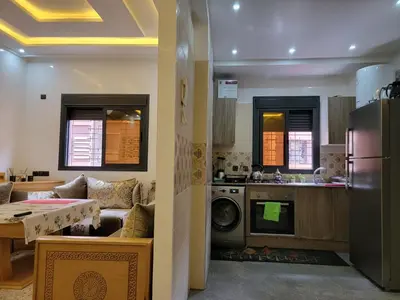 a kitchen and living room with a washer and dryer at Appartement racha in Marrakech