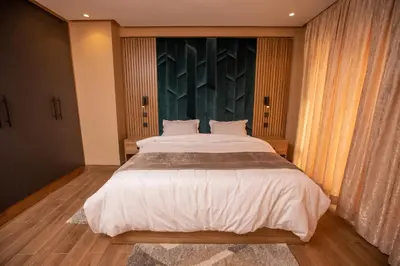 a bedroom with a large bed and a large window at Élégance et Prestige à Gueliz Appartement 3 chambres in Marrakech