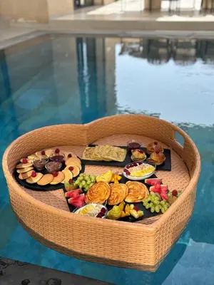 a basket filled with different types of food in a pool at Villa Kenza piscine et jacuzzi chauffée in Marrakech