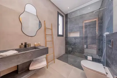 a bathroom with a sink and a shower at Villa Kenza piscine et jacuzzi chauffée in Marrakech