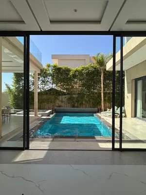 a swimming pool in the middle of a house at Villa Kenza piscine et jacuzzi chauffée in Marrakech