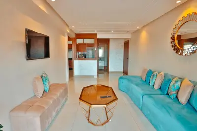 a living room with a blue couch and a table at Best Apartment Marrakech G35 in Marrakech