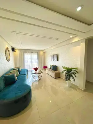a large living room with a blue couch and a table at Best Apartment Marrakech G35 in Marrakech