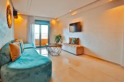 a living room with a couch and a chair at Best Apartment Marrakech G35 in Marrakech