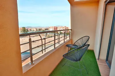 a balcony with two chairs and a view of the beach at Best Apartment Marrakech G35 in Marrakech