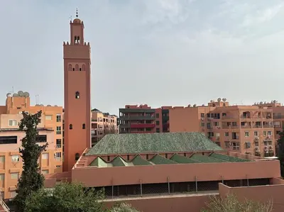 a building with a clock tower in a city at Stylish & Comfy Appartment Haven 5 Stars Location Plaza Views in Marrakech