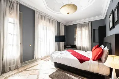 a bedroom with a large bed with red pillows at Villa palmeraie marrakech in Marrakech