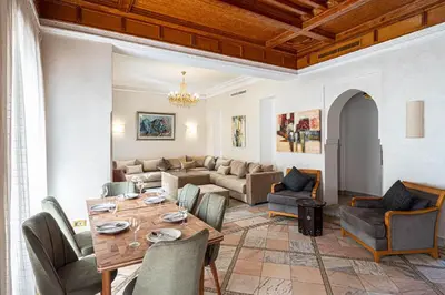 a living room with a table and a couch at Villa palmeraie marrakech in Marrakech