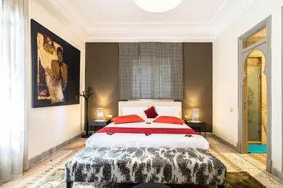 a bedroom with a large bed with red pillows at Villa palmeraie marrakech in Marrakech