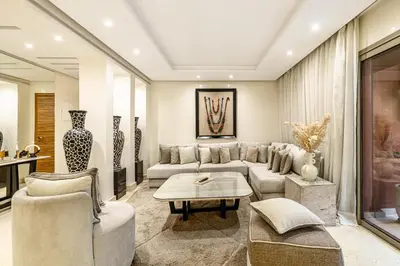 a living room with a couch and a table at Luxury 2-Bedroom Apartment in City Center Jacuzzi & Heated Pool in Marrakech