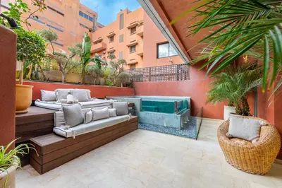 a patio with a hot tub on a building at Luxury 2-Bedroom Apartment in City Center Jacuzzi & Heated Pool in Marrakech