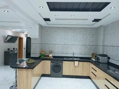 a kitchen with a washing machine and a sink at Villa fahloui in Marrakech