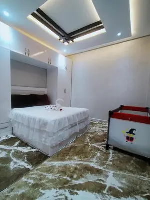 a bedroom with a bed and a marble floor at Villa fahloui in Marrakech