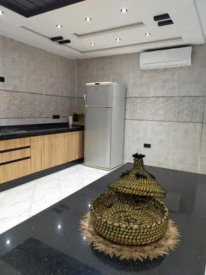 a kitchen with a counter and a refrigerator at Villa fahloui in Marrakech
