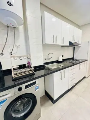 a kitchen with a washing machine and a sink at Cosy House Marrakech Semlalia - Gueliz Center in Marrakech