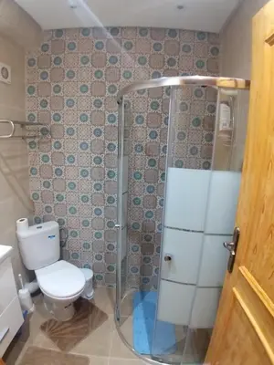 a bathroom with a toilet and a shower at Sweet home in Marrakech