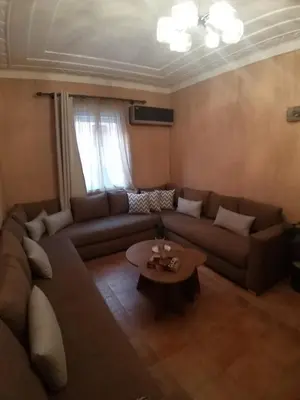a living room with a couch and a coffee table at Sweet home in Marrakech